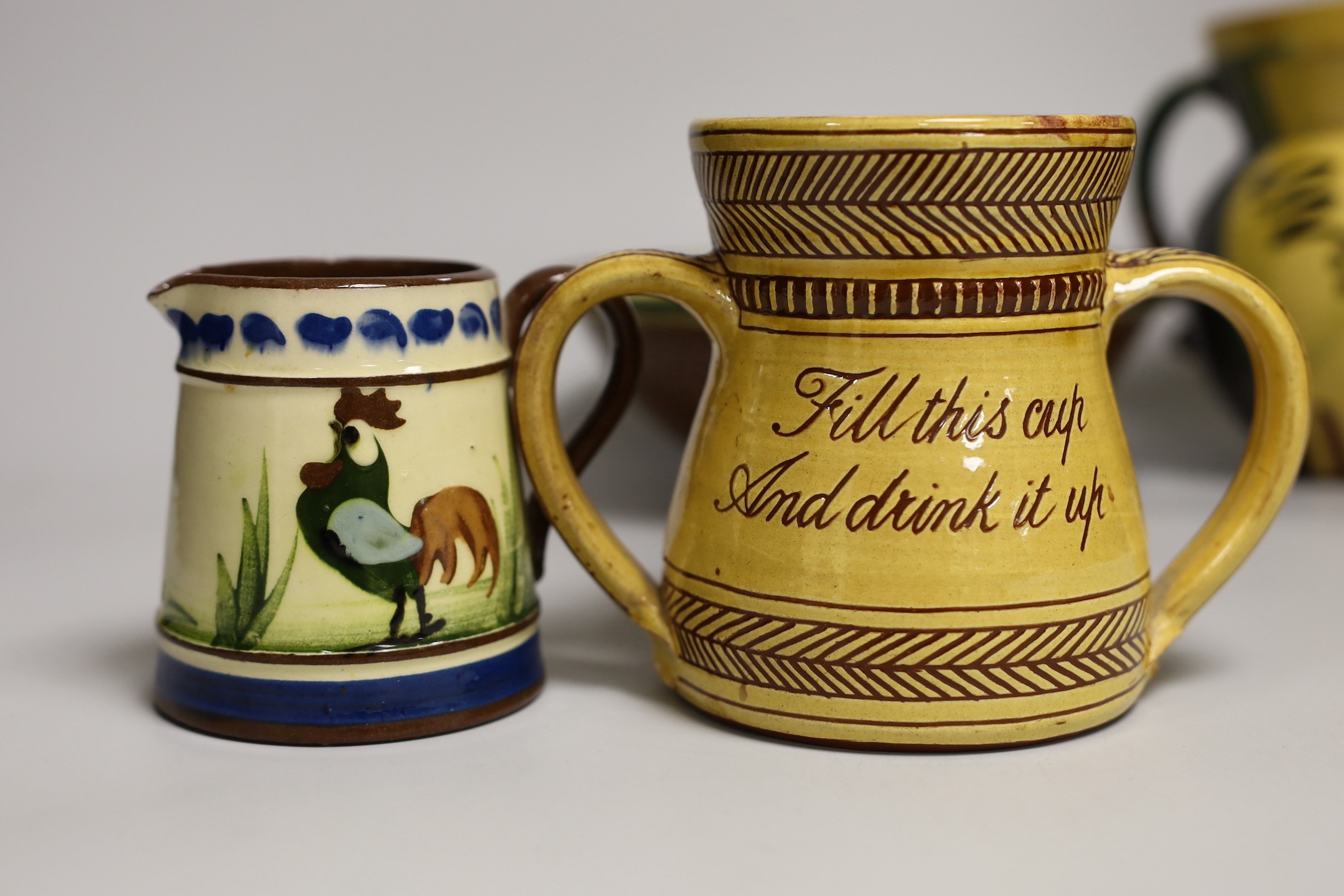 Margaret Brompton studio pottery bowl with insects, together with a slipware jug, a Longpark, Torquay small cockerel jug, and a Susan Juniper slipware jug, largest 21cm diameter, (4)